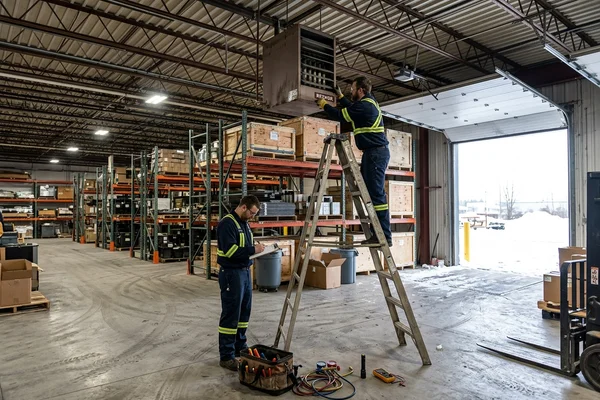Servicing a suspended unit heater in winter